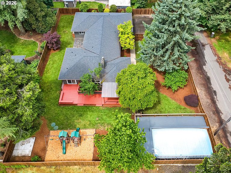 Aerial view of the .37-acre lot at 6286 SW Harrington Ave in Lake Oswego, Oregon, showing the single-story 1952 ranch footprint, mature firs, raised garden beds, and the heated pool on the back deck